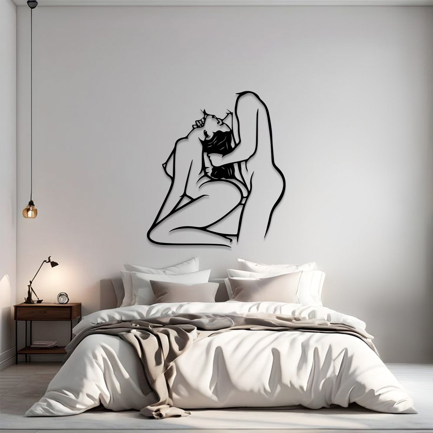 A minimalist bedroom scene with a large black line-art wall sculpture of a couple embracing, mounted on a light gray wall above a neatly made bed with white and beige bedding.