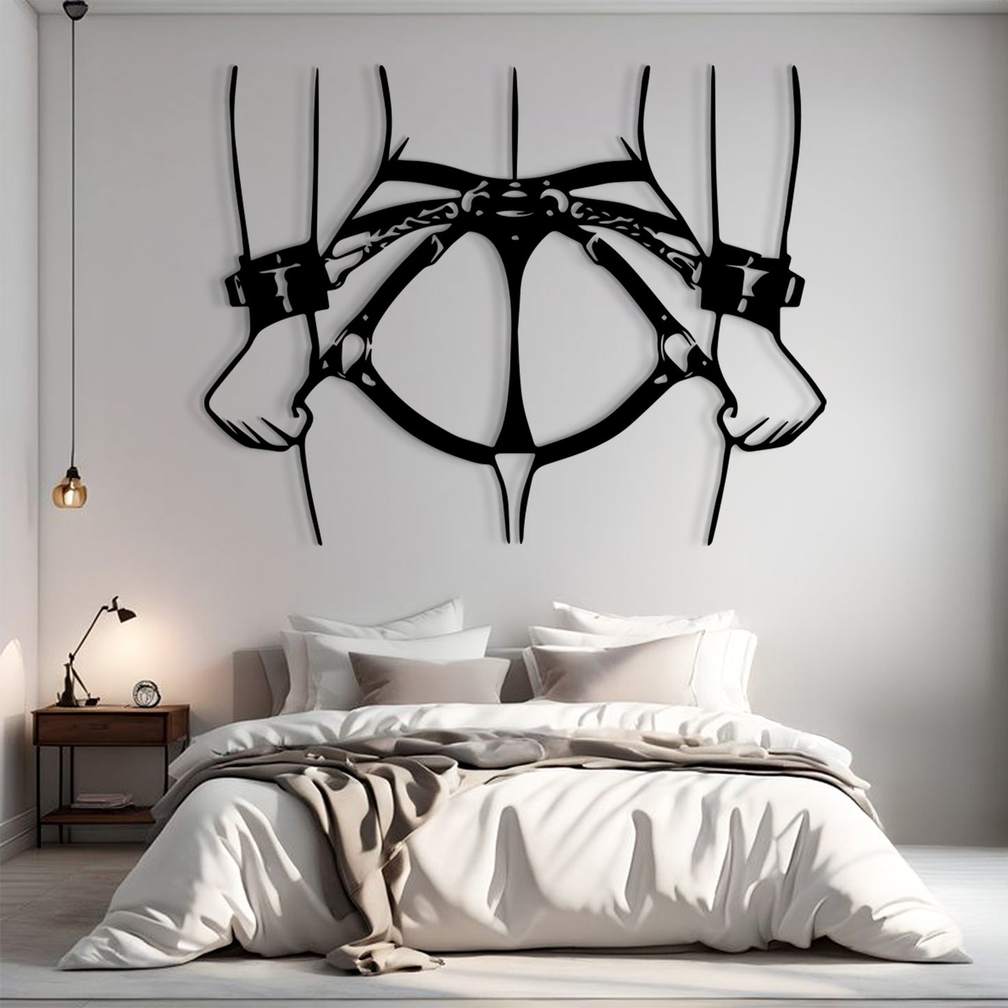 A large black metal wall art piece depicting a harness or collar design hangs above a neatly made bed in a modern bedroom setting.
