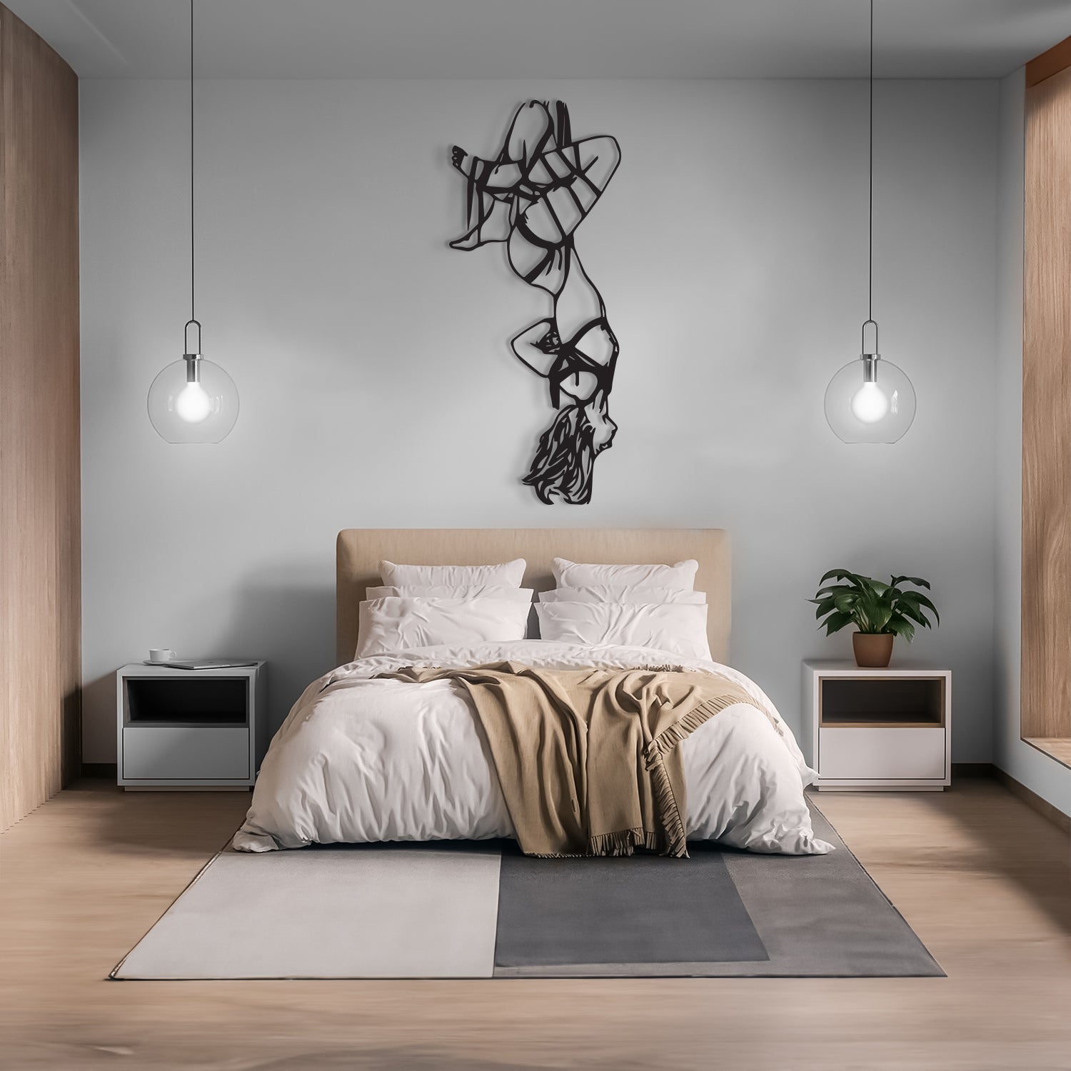 A modern minimalist bedroom featuring a bed with white bedding and a beige throw blanket, flanked by two white nightstands with silver accents. The room has light wood flooring, a gray wall with a black wire art piece, and two hanging glass globe lights.