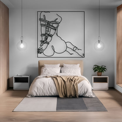 A modern bedroom featuring a large black and white minimalist line art print of a crouched figure with strappy details, hung on a light gray wall above a beige upholstered bed with white bedding and a tan throw blanket.