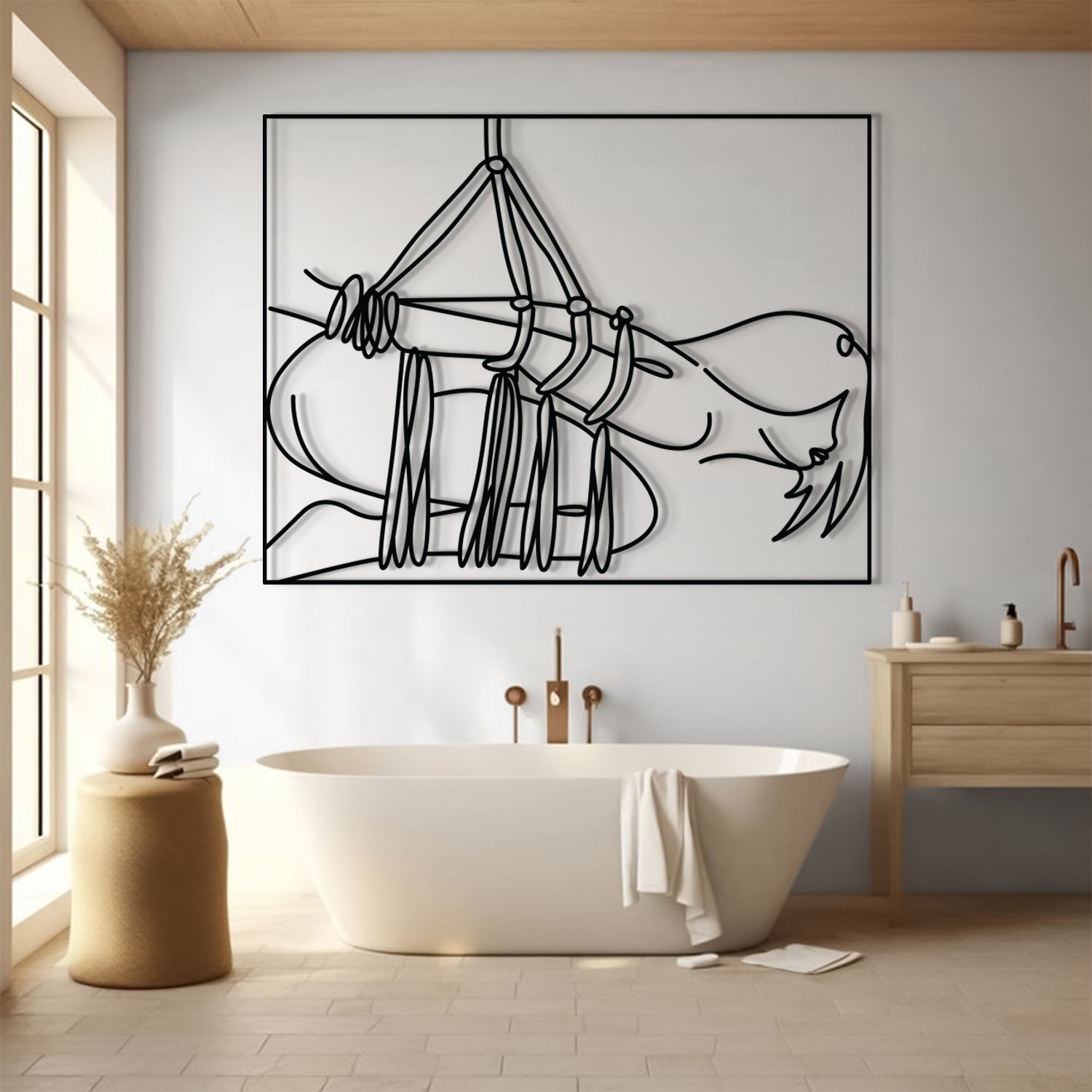 A minimalist black line art wall hanging depicting a hammock and draped fabric, displayed in a modern bathroom above a freestanding bathtub.