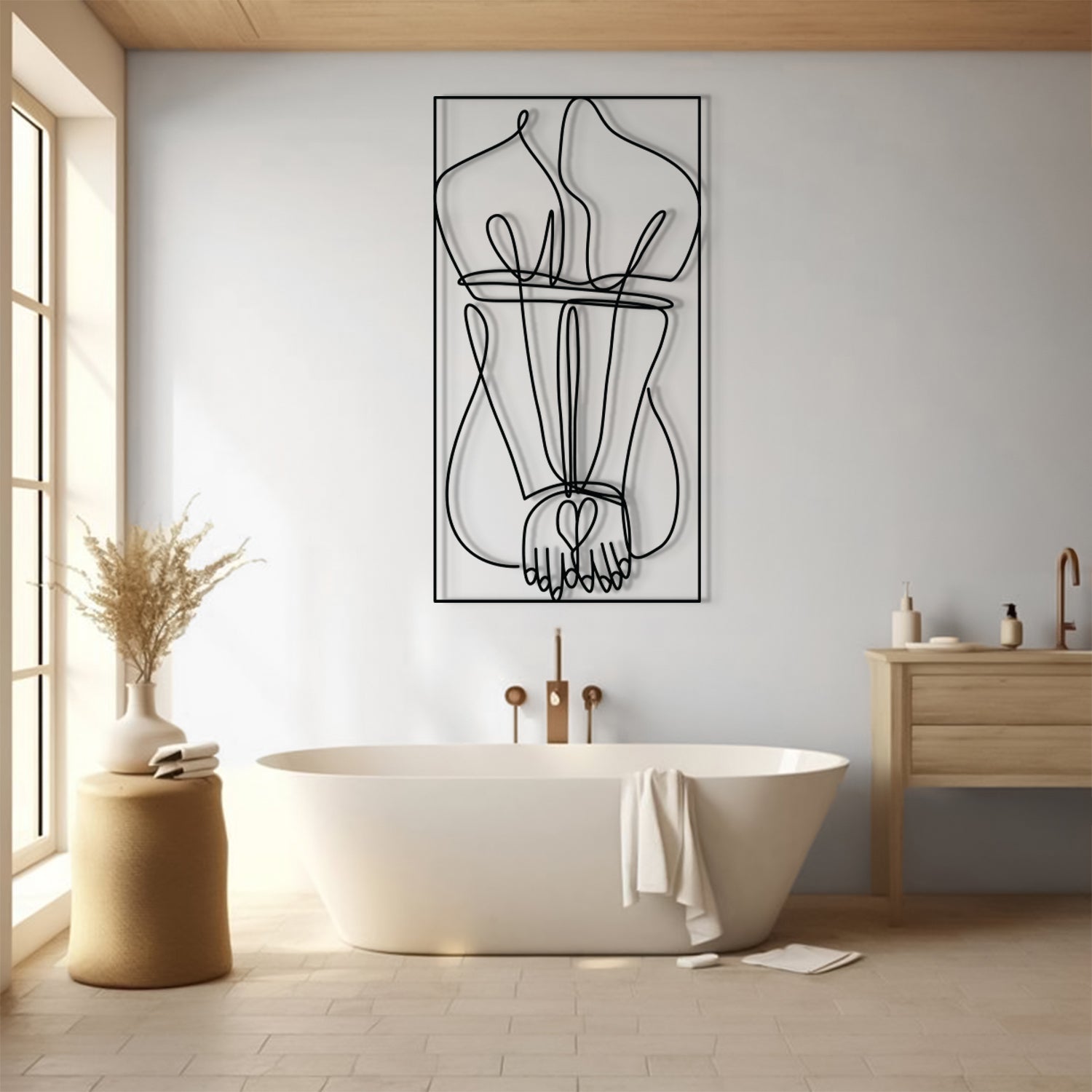 A minimalist black wire art print of a censored face hangs on a light gray wall above a white freestanding bathtub in a bright, modern bathroom with a wooden vanity and warm wood floor.