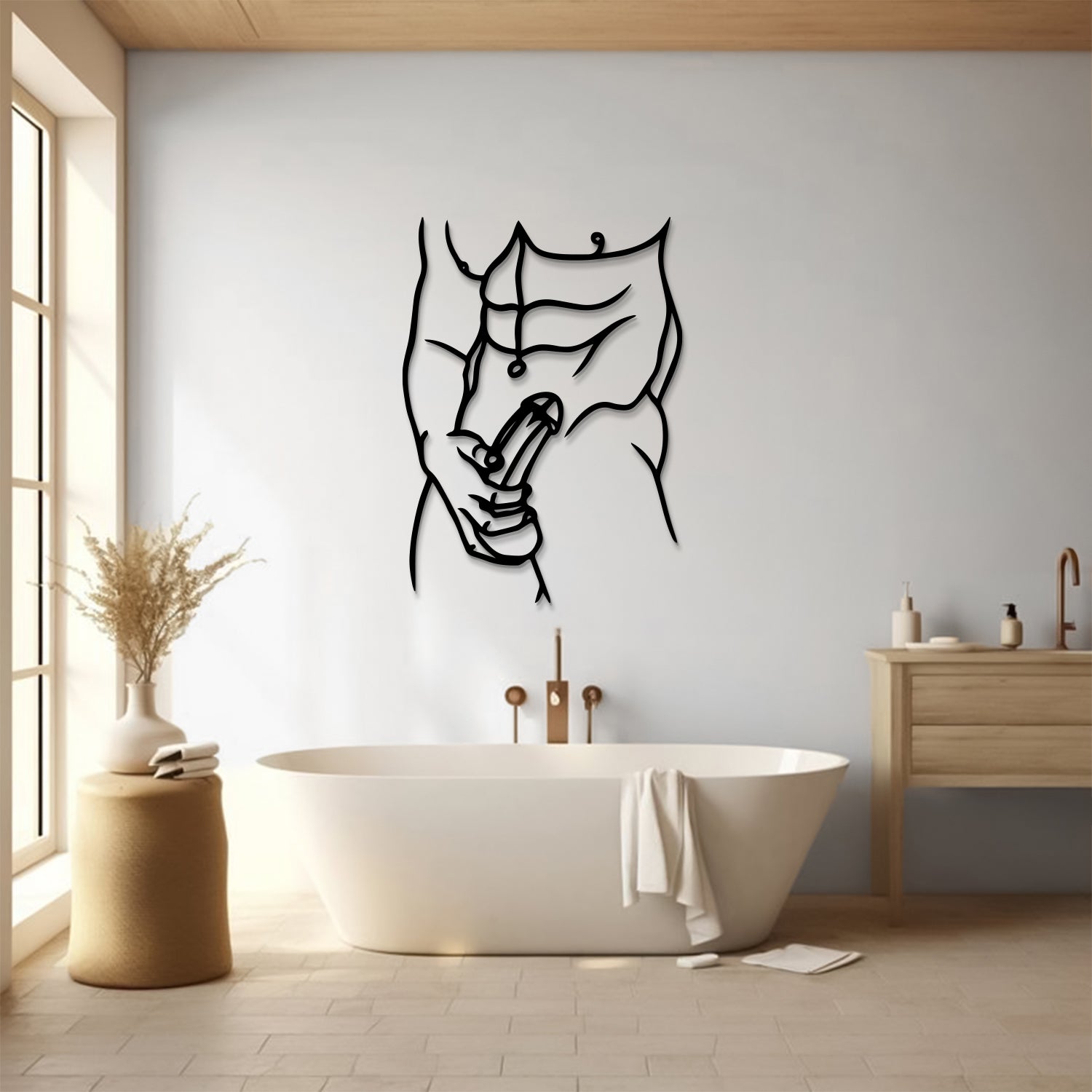 A minimalist black metal wall art piece depicting a muscular male torso and hand performing a penis stroke, displayed on a light gray wall in a modern bathroom setting with a freestanding bathtub, wooden vanity, and window.