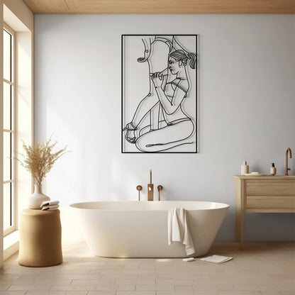 A framed black and white minimalist line art print of a woman sitting on a chair, displayed on a light gray wall in a modern, sunlit bathroom with a freestanding bathtub and wooden vanity.