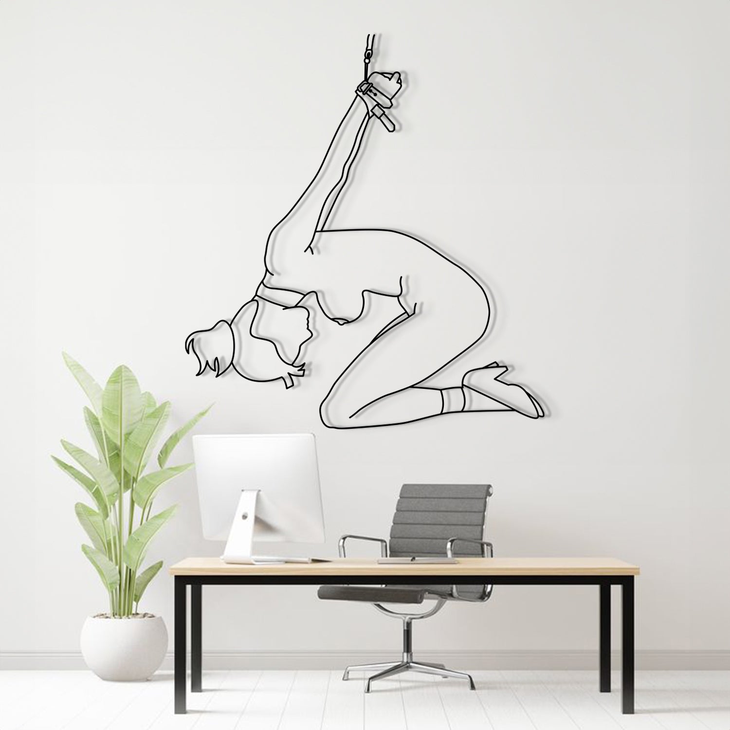 Modern office interior with a wall decal of a woman in a yoga pose.