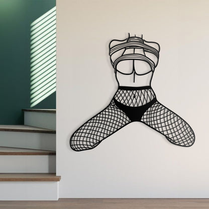 Black wall decal of a stylized figure on a white wall with stairs in the background.