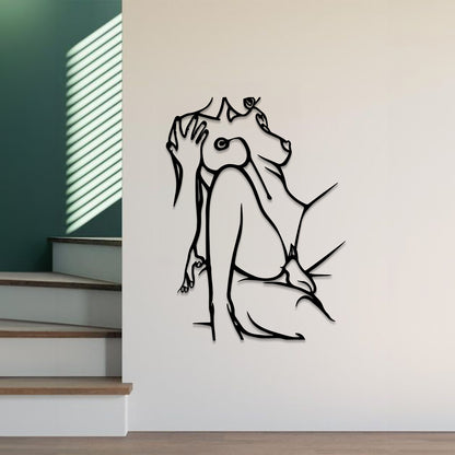 Black metal wall art depicting a stylized dog, mounted on a white wall in a modern interior setting with a staircase and green wall visible.