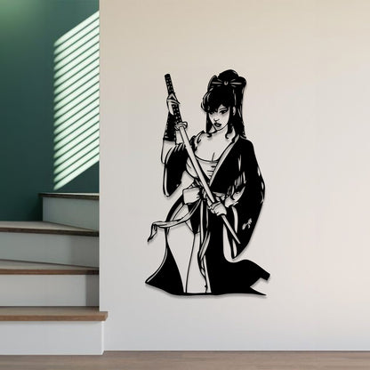 A black metal wall art piece depicting a female samurai warrior holding a sword, mounted on a light beige wall in a modern interior setting with stairs and window blinds visible.