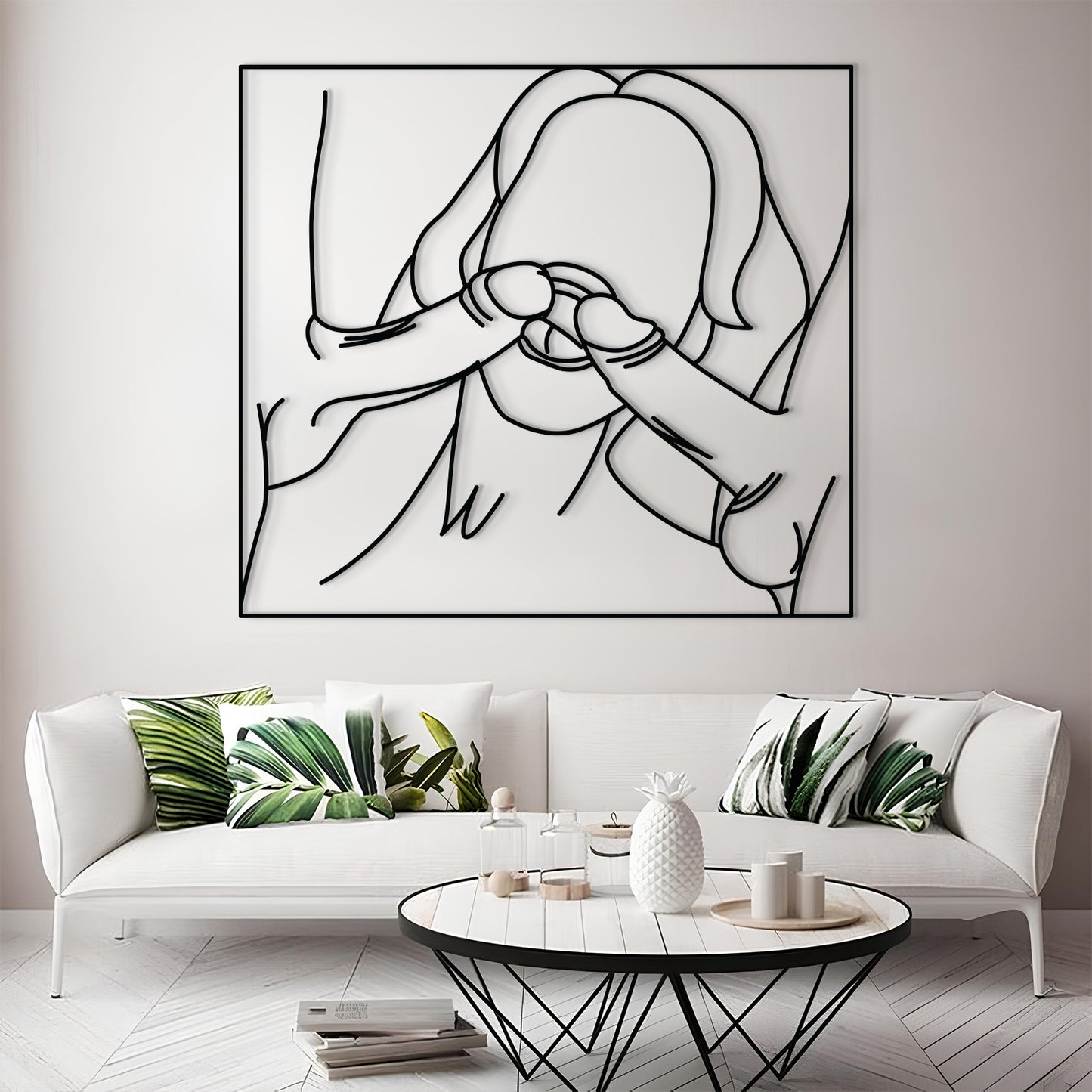 A large black metal wall art piece featuring a minimalist line drawing of a person, displayed above a white sofa in a modern living room setting.