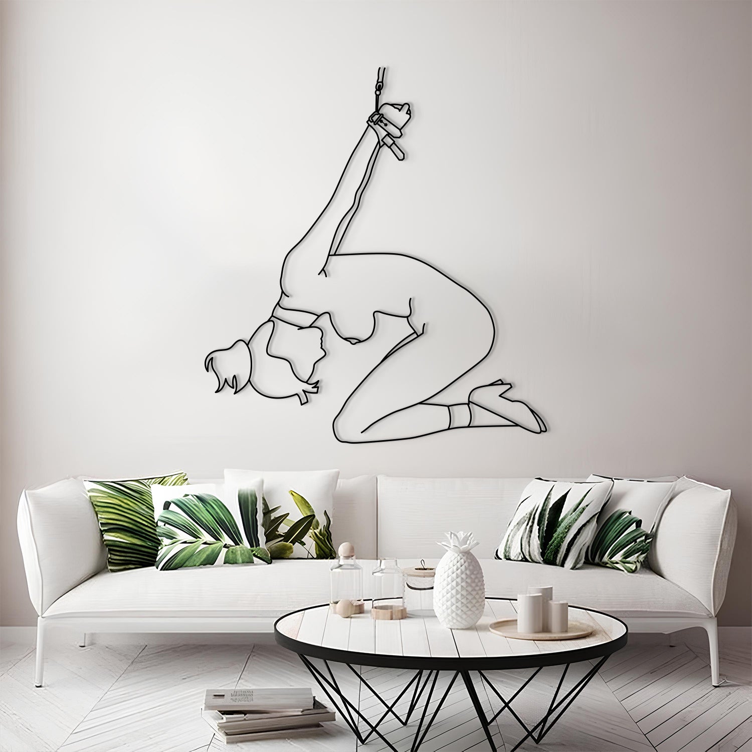 Living room with a white sofa, decorative pillows, and a wall art of a gymnast.