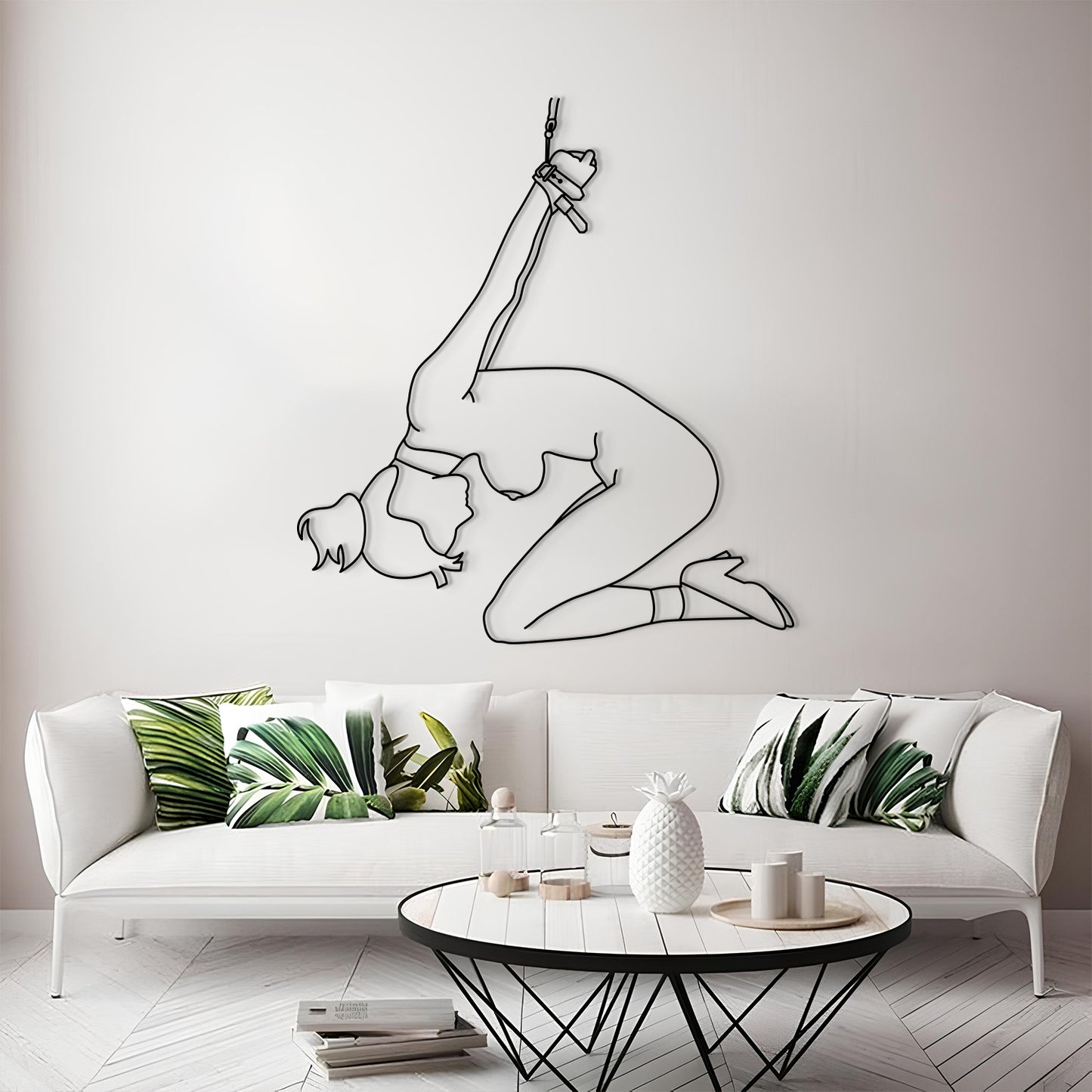 Living room with a white sofa, decorative pillows, and a wall art of a gymnast.