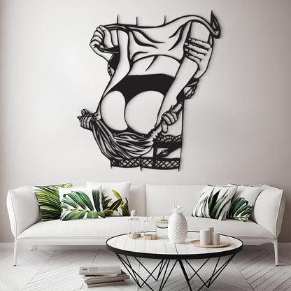 A black metal wall art piece depicting a stylized figure lifting a garment, displayed above a white sofa in a modern living room setting.
