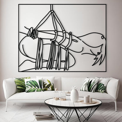 A large black and white minimalist line art print of a hammock hanging above a white sofa in a modern living room setting.