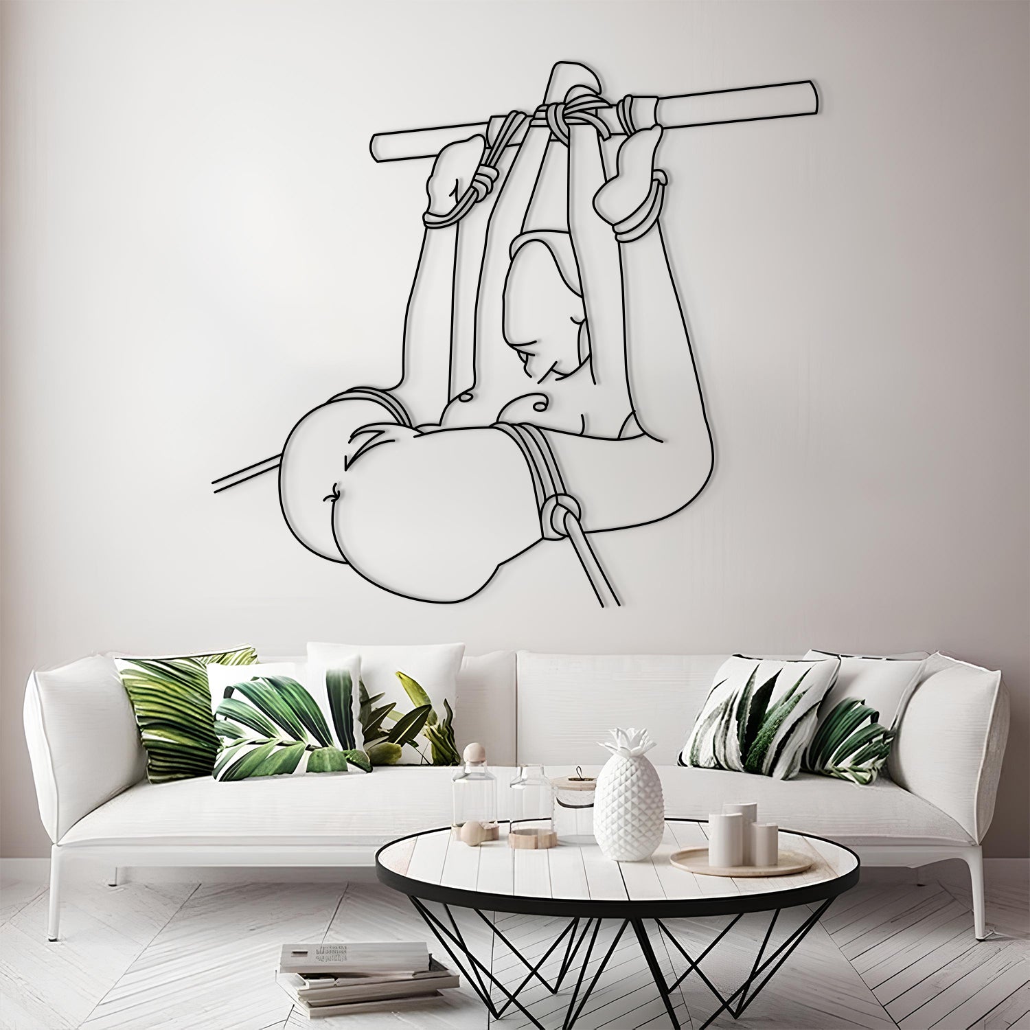 Modern living room with a white sofa, decorative pillows, and a wall art of a monkey holding a banana.