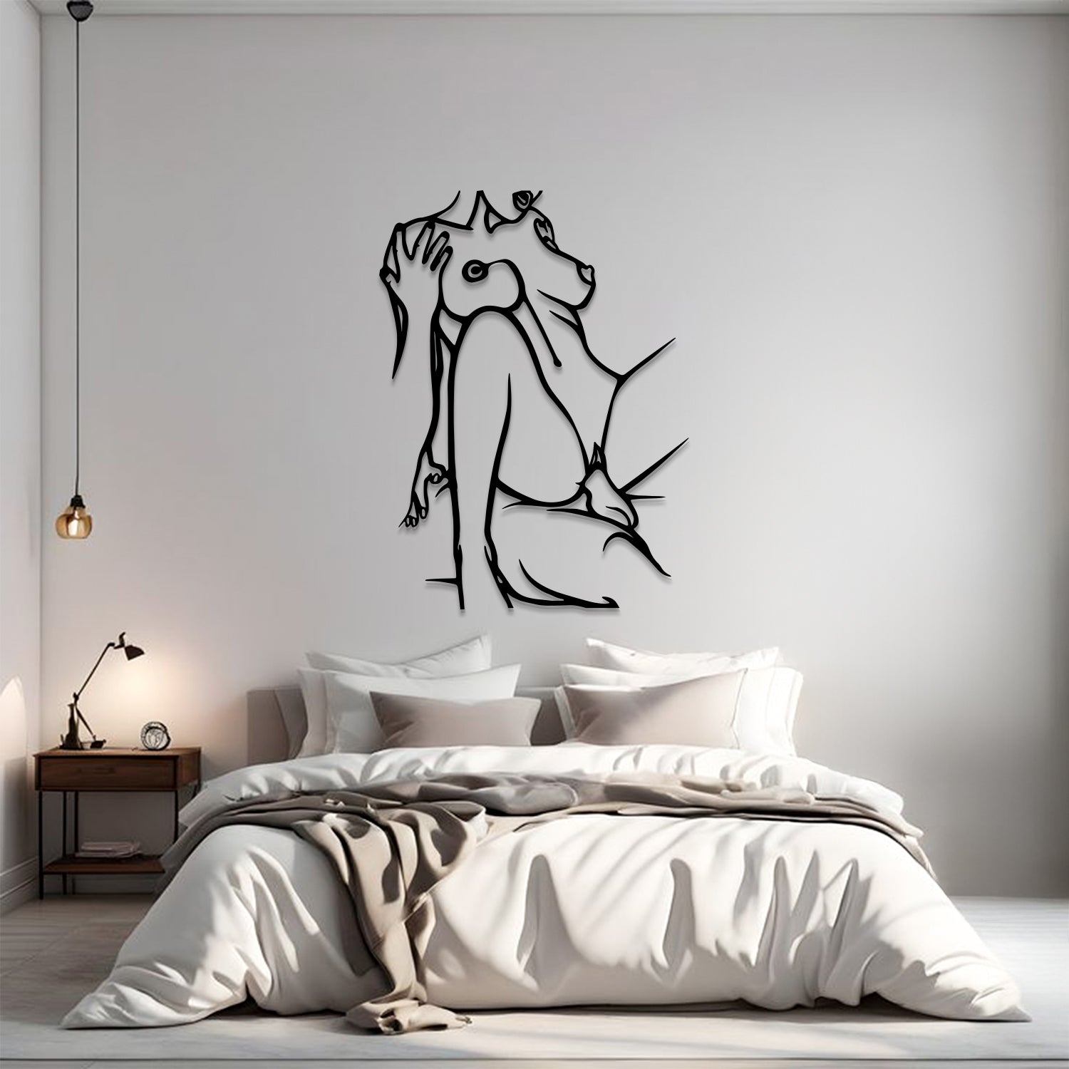 A modern bedroom scene with a minimalist black line art wall decal of a dog sitting up on the wall above a neatly made bed with white and beige bedding.