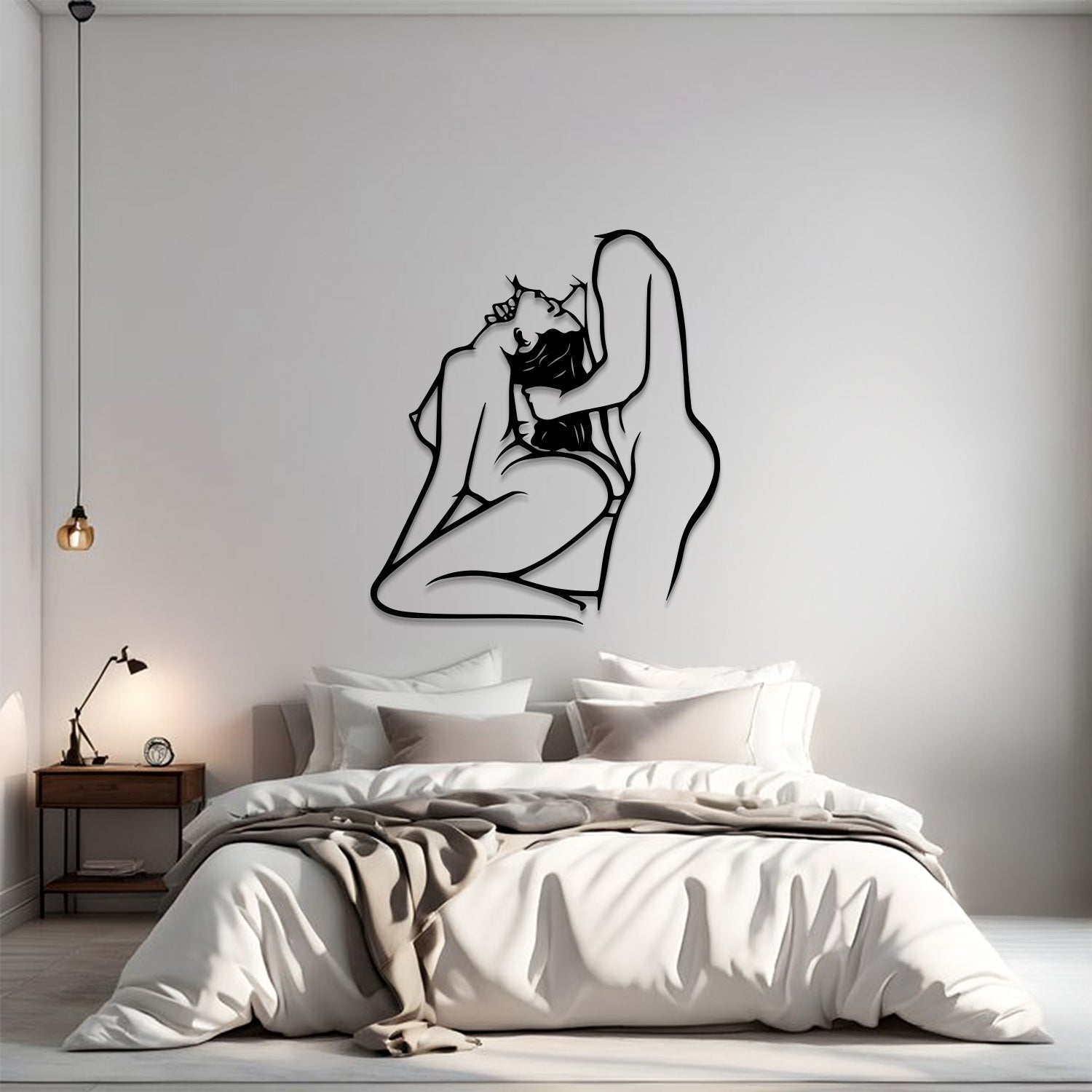 A minimalist bedroom scene with a large black line-art wall sculpture of a couple embracing, mounted on a light gray wall above a neatly made bed with white and beige bedding.