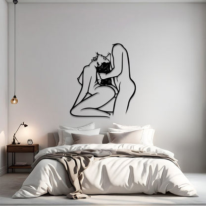 A minimalist bedroom scene with a large black line-art wall sculpture of a couple embracing, mounted on a light gray wall above a neatly made bed with white and beige bedding.