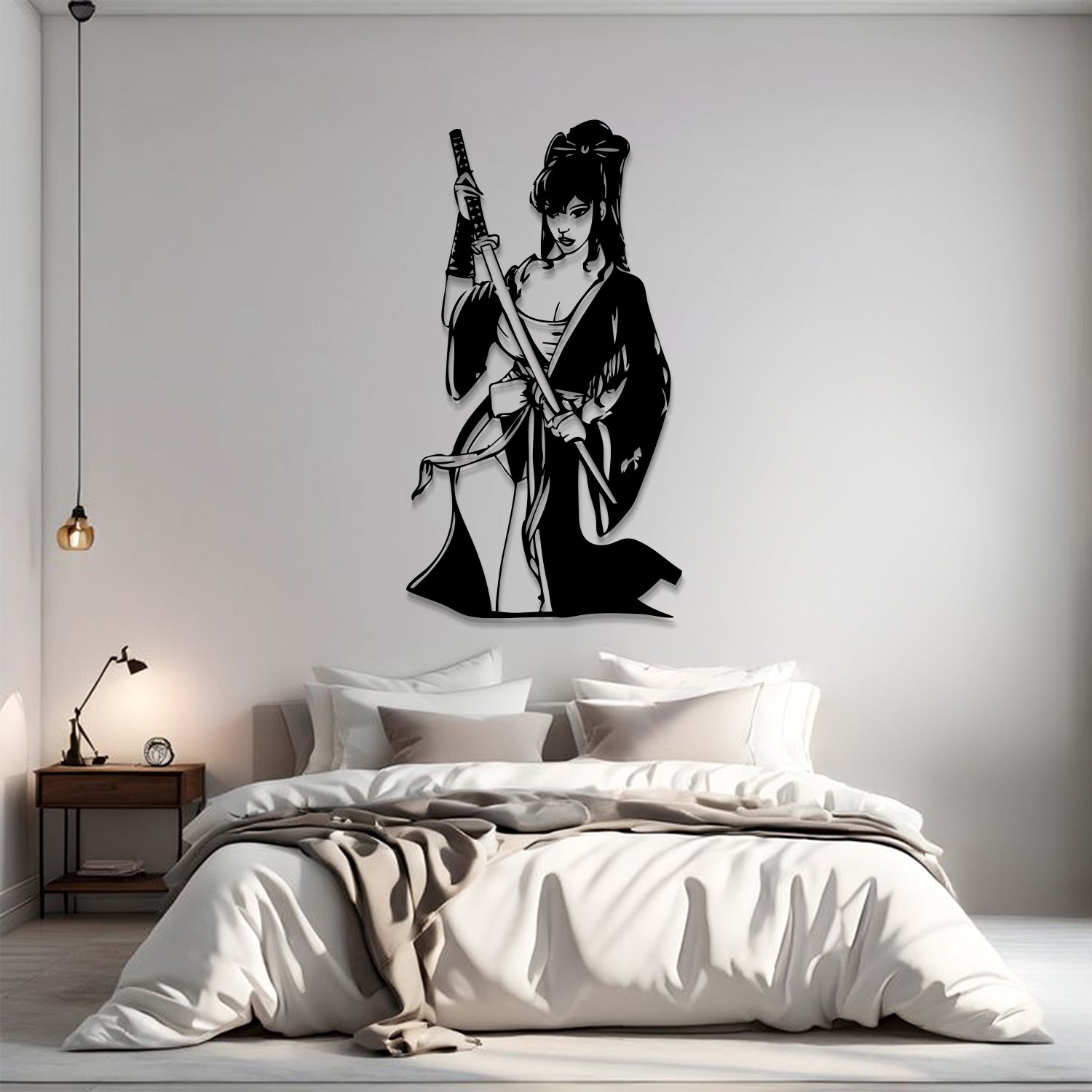 A black vinyl wall decal of a samurai woman holding a sword, displayed on a light gray wall above a neatly made bed in a modern bedroom setting.