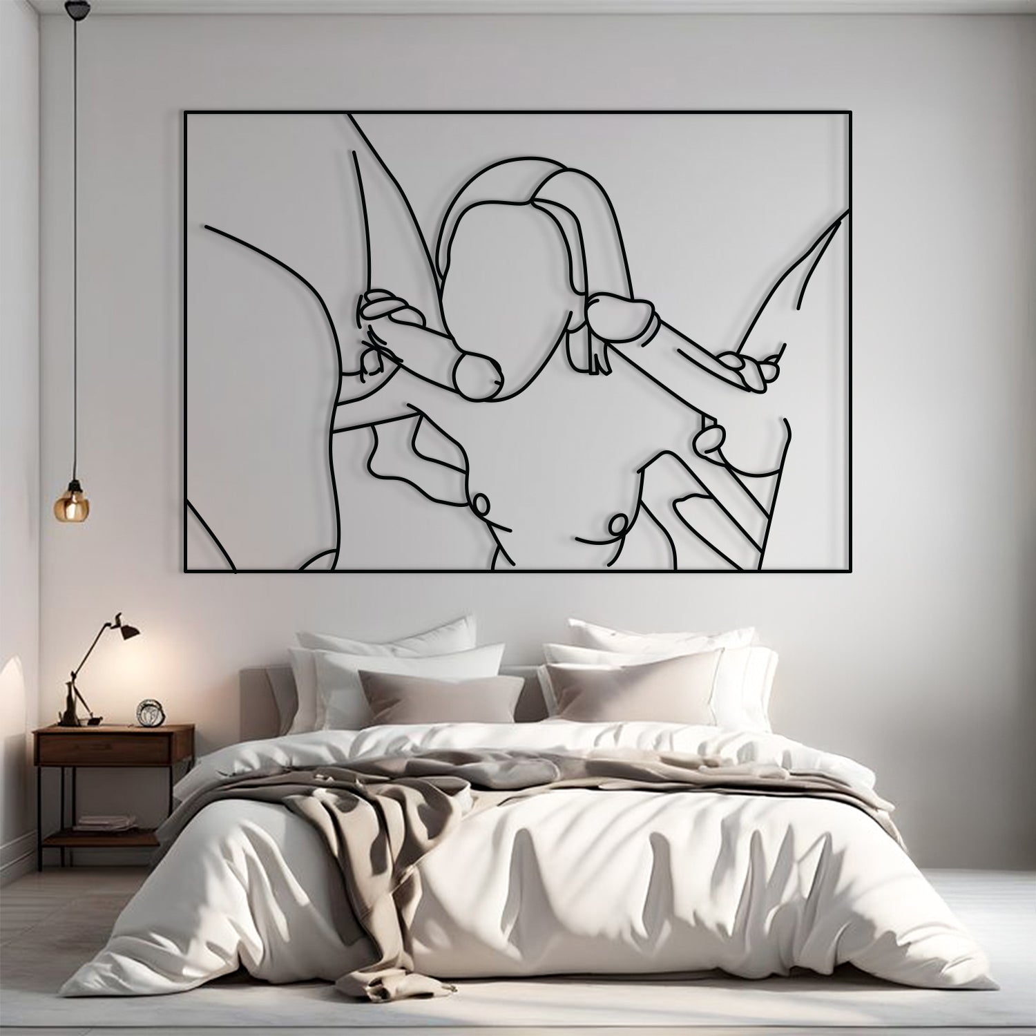 A minimalist black continuous-line wall art print depicting a couple embracing, displayed in a modern bedroom setting above a neatly made bed with white and beige bedding.