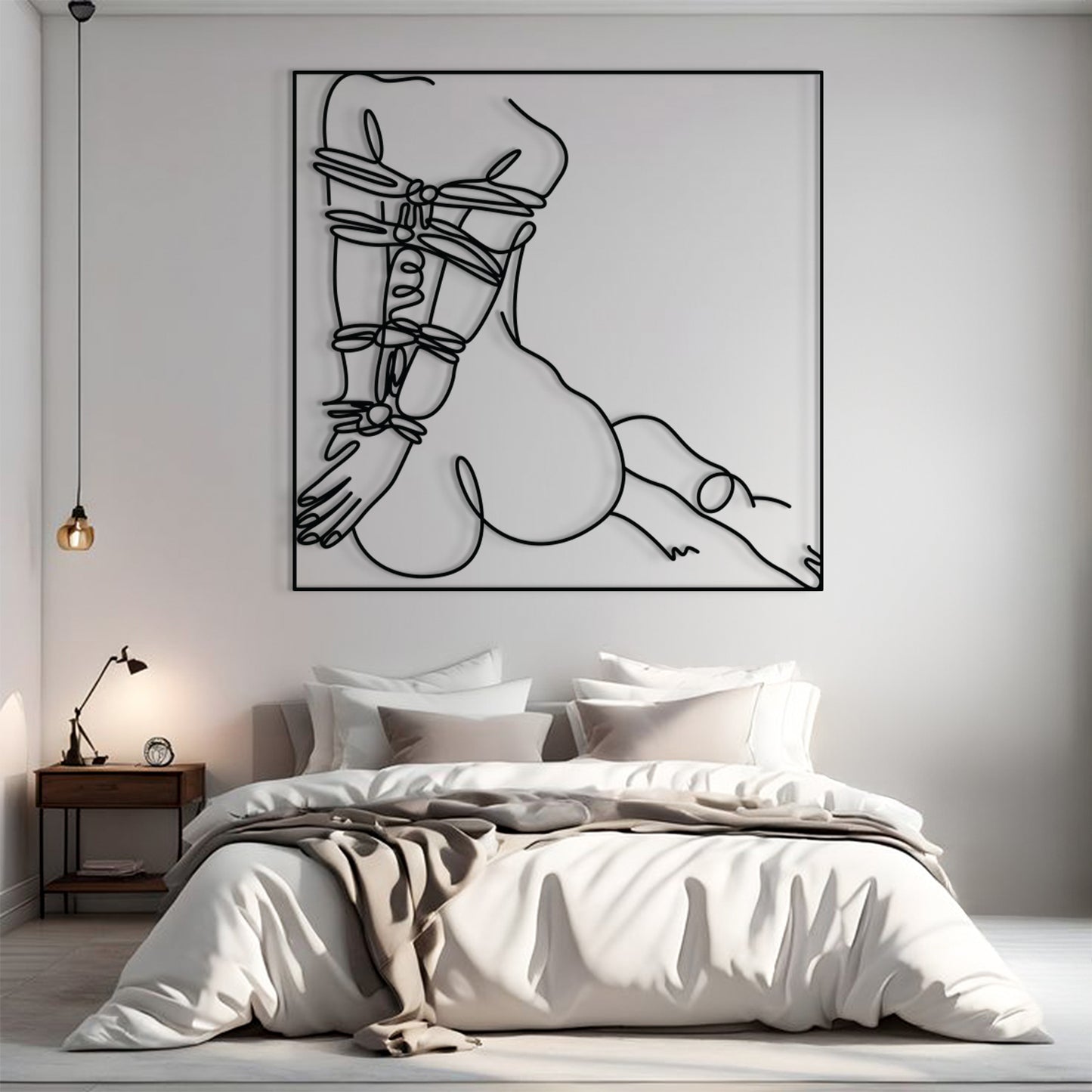 A minimalist black line art print of a crouched figure wrapped in straps, displayed on a light gray wall above a neatly made bed in a modern bedroom setting.