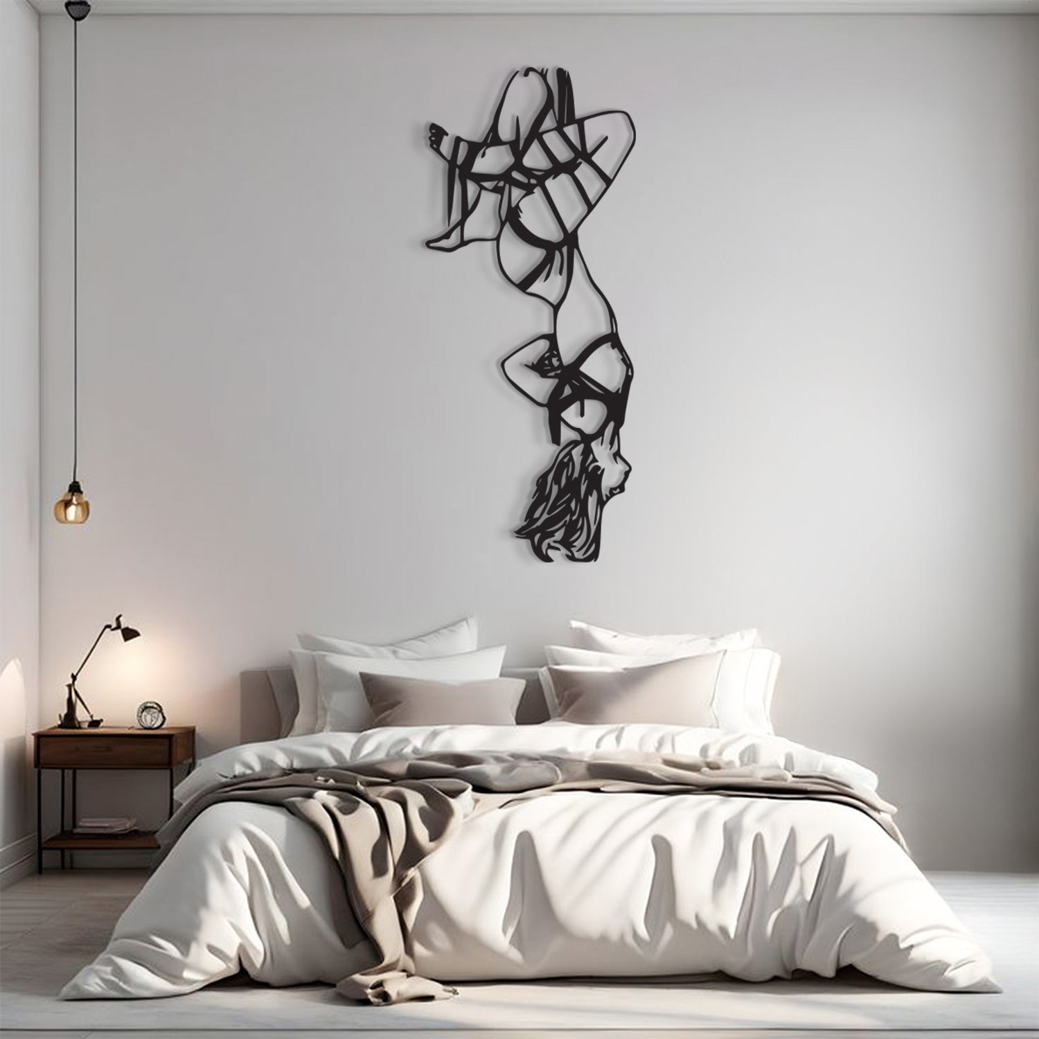 A modern bedroom scene with a bed dressed in white and beige bedding, a small wooden nightstand with a lamp, and a large black abstract wall sculpture mounted on a light gray wall above the bed.