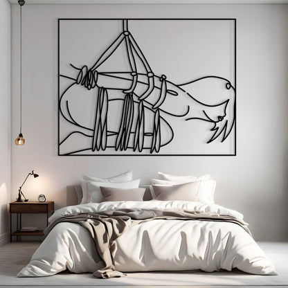 A large black and white minimalist line art wall print depicting a hanging figure, displayed above a neatly made bed in a modern, neutral-toned bedroom.