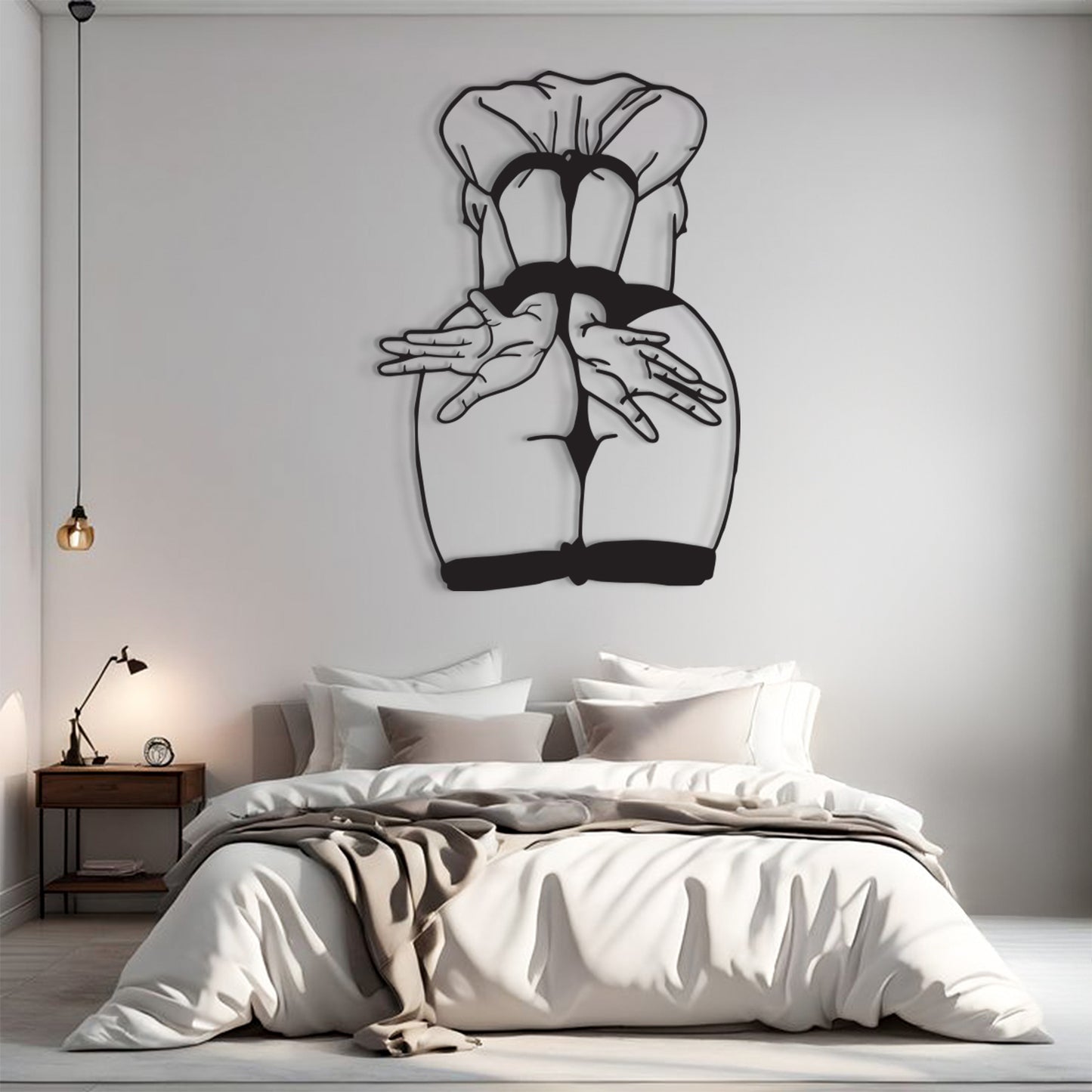 A modern bedroom interior with a large black metal wall art piece depicting a stylized female back and hands, mounted above a bed with white bedding and a wooden nightstand.
